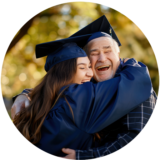 Alumi_Graduation_FatherDaughterHug W512px